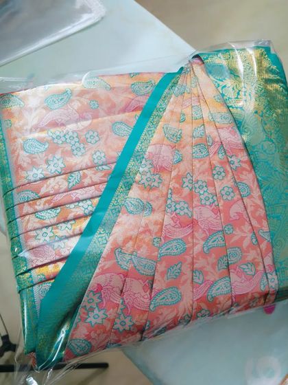 A pre-pleated and box-folded saree, packed and ready for a client. My service ensures your saree is event-ready.