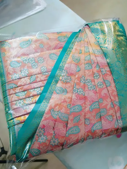 A lovely floral saree, packed and ready for the client. My service ensures that even delicate sarees are handled with professional care.