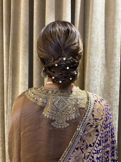 The full back view of the pearl-adorned textured bun. It's a masterpiece of twists and braids, creating a look that is both complex and effortlessly beautiful.