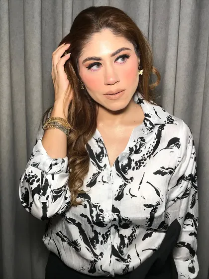 The soft waves and matte makeup create a sophisticated and trendy look.