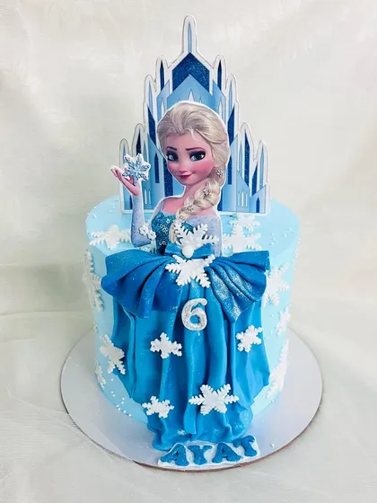 Full view of the Elsa cake with her fondant dress and snowflake details.