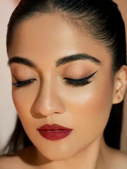 The perfect winged liner, seen with eyes closed. The line is crisp, black, and follows the natural shape of the eye for a lifting effect.