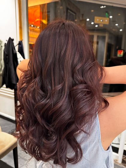 A final shot of the brown global hair color, capturing the beautiful curls and the richness of the shade.
