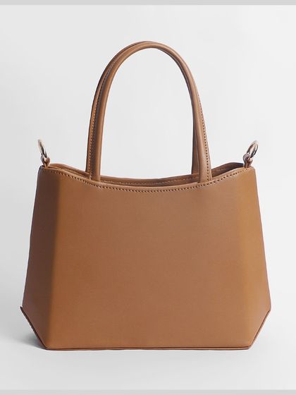 A back view of the same beige handbag.