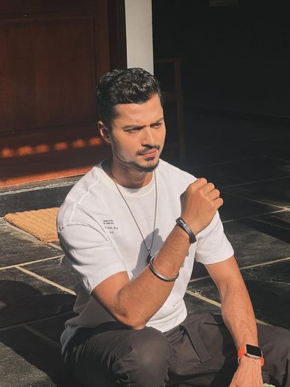 Soaking up the sun in a simple white t-shirt and black pants. A classic, cool look for any day.