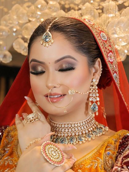 A close-up showcasing the intricate details of this bridal look. The smokey eye, radiant skin, and beautiful jewelry come together for a truly sophisticated feel.