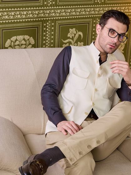 A more casual, intellectual styling of the four-pocket waistcoat. It's a piece that speaks of quiet luxury and thoughtful design.