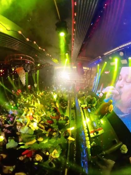 A wide-angle shot showing the scale of the party at Sugar Factory, with me on the elevated DJ console.