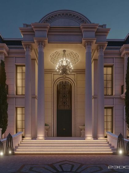 The entrance of this palatial villa is designed to be a spectacle of grandeur. Double-height Corinthian columns frame a magnificent doorway, while a large chandelier illuminates the coffered ceiling above the steps.