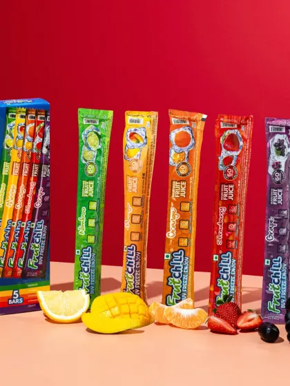 A colorful lineup of the full range of fruit pops, with each flavor matched to its corresponding fresh fruit. This kind of shot is great for showing customers the variety available in a clean and organized way.