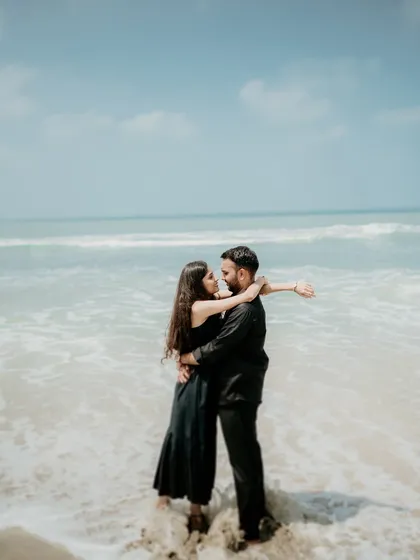 A romantic embrace in the waves. This photo captures the couple's adventurous spirit and their connection amidst the power and beauty of the ocean.