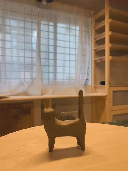 A charming ceramic cat sculpture, named Luna. A reminder to cherish our quiet moments.