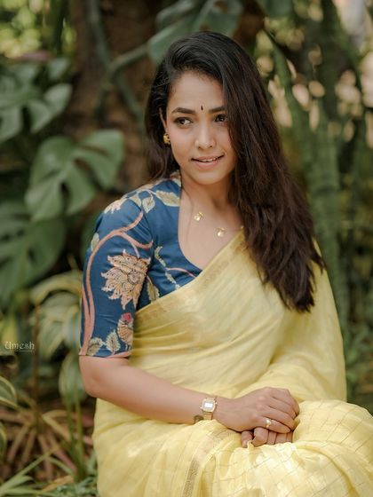 A classic portrait that captures her elegance and the beauty of the saree and blouse combination. A timeless look for any occasion.