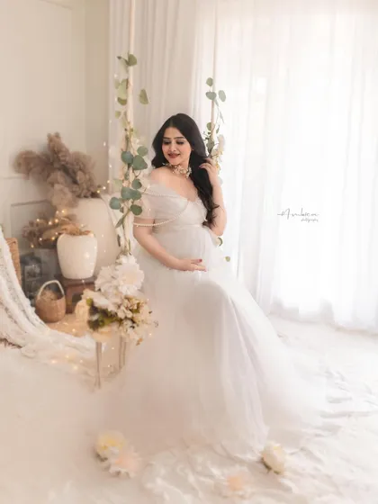 A wider angle of the swing setup, showing the dreamy ambiance created with fairy lights and soft fabrics. This portrait has a magical, enchanting quality.