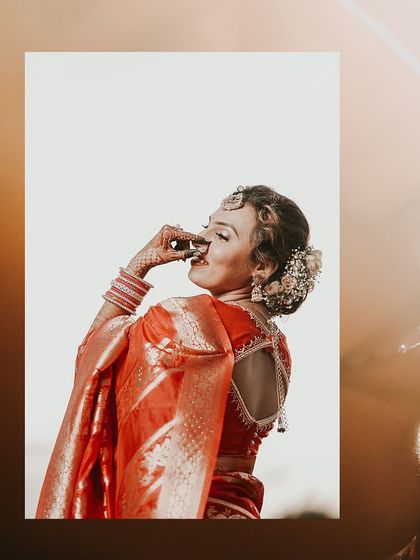 A beautiful, sun-kissed portrait of the bride-to-be in a traditional saree, capturing her joyful and playful expression.