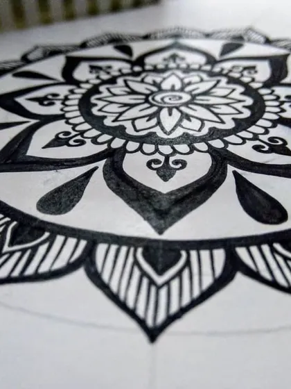 The beginning stages of a floral mandala. I start with the central elements and work my way out, letting the pattern grow organically. There's no need to rush; the magic is in the making.