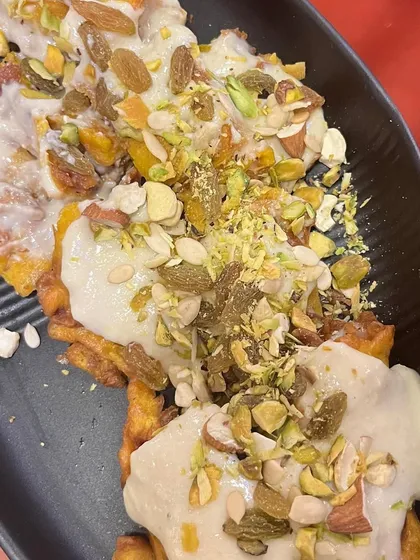 Our Special Dryfruit Malpua, loaded with pistachios, almonds, and raisins. It's a richer, more indulgent version of the classic dessert.