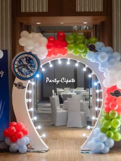 The entrance to Ayansh's fighter jet party featured a lighted archway, a personalized welcome sign, and balloon clouds to make guests feel like they were entering an airbase.
