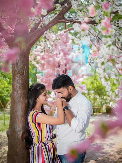 A chivalrous and romantic gesture, as the groom-to-be kisses his partner's hand. It's these small moments that add a touch of elegance to a pre-wedding shoot.