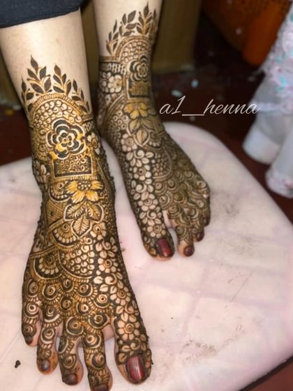 A close-up of a bridal foot design, showing how the pattern extends from the ankle to the toes.