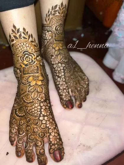 A close-up of the bridal leg design, showing the rich color of the fresh henna paste and the flawless application.