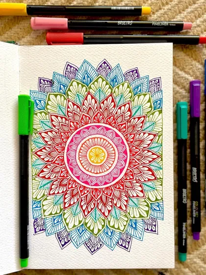 A flat lay of my rainbow mandala, showcasing the vibrant pens used. Good quality tools make the creative process so much more enjoyable.