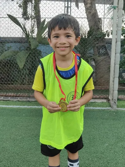 A happy Player of the Month, recognized for being a great teammate and a hard worker.