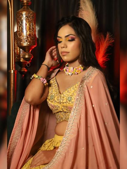 Master the art of flawless makeup. This look is perfect for a Haldi or Mehendi function, with its bright, colorful eye makeup.