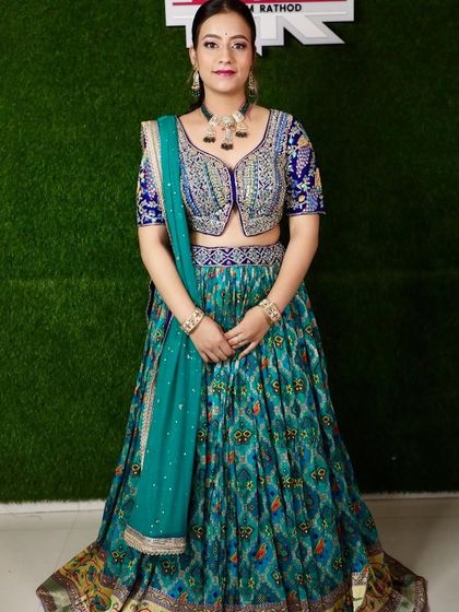 A full shot of the client in the teal printed lehenga, looking elegant and poised.
