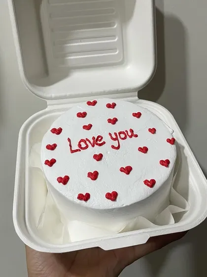 A classic 'Love you' bento cake with red hearts, perfect for Mother's Day or any day you want to show appreciation.