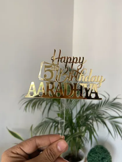A simple and clear design for a child's birthday. This "Happy 5th Birthday AARADHYA" topper uses a mix of fonts to create a fun and readable piece, perfect for capturing memories.
