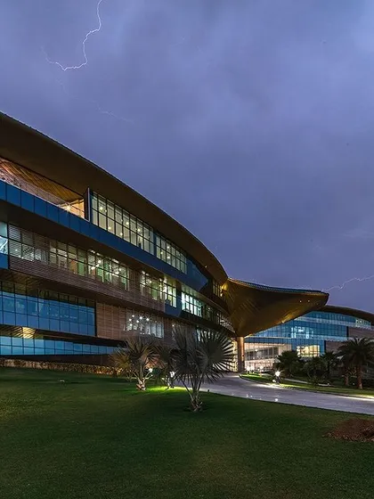 The Jaquar Global Headquarters captured against a dramatic sky. This project showcases our ability to create dynamic, large-scale commercial architecture that is both a landmark structure and an energy-efficient, net-zero building.