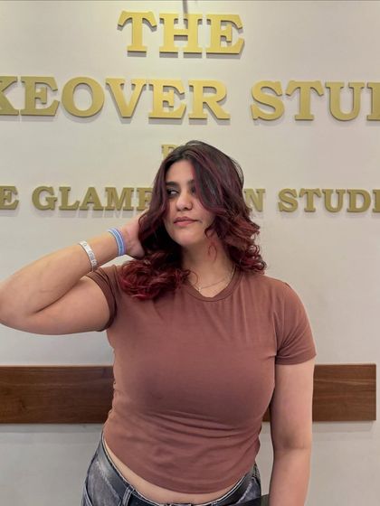 From simple to stunning. This client is owning her vibe with a bold red transformation, complete with soft curls to show off the color's dimension.