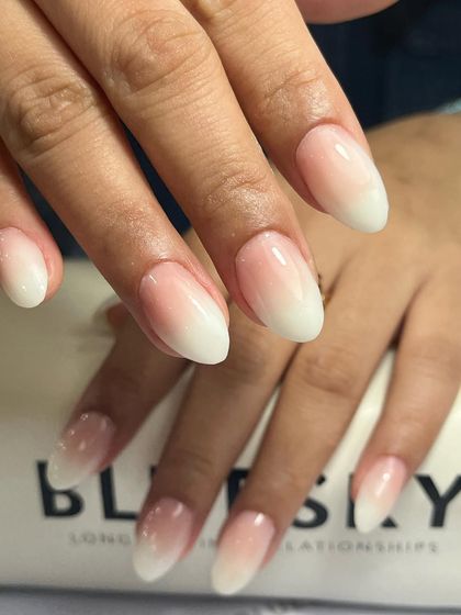 A full view of these elegant baby boomer nails on an almond shape. The gradual fade is smooth and flawless, creating a sophisticated and clean aesthetic.