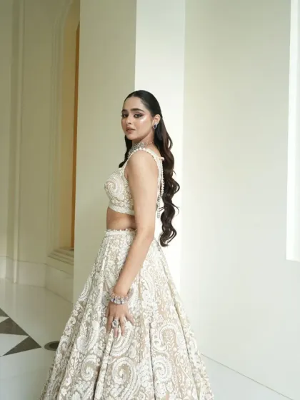 A side profile capturing the elegant silhouette of the lehenga. The styling is all about creating a look that is both modern and timeless.