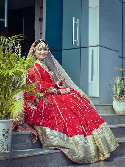 A full-length shot of a traditional red bridal lehenga look, created by one of our students. We ensure our students learn professional posing and photography tips to best showcase their work.