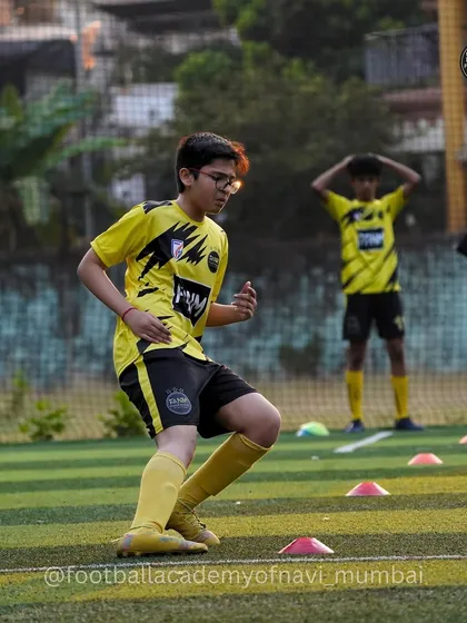 A player practices quick feet and reaction time during an agility drill.