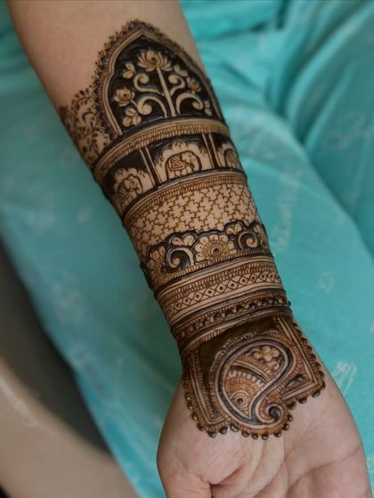 A detailed shot of the arm, showing the beautiful bands of patterns, including elephant motifs.