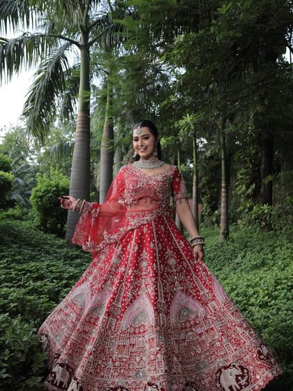A full, joyous shot of the bride in her element, surrounded by nature. The lehenga's flare and movement are captured perfectly here.