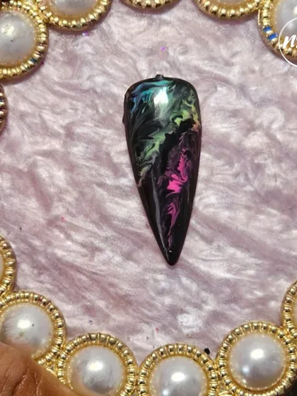 A dramatic and mesmerizing marble ink design on a black base. Our students learn to use different materials to create these stunning, galaxy-like effects.