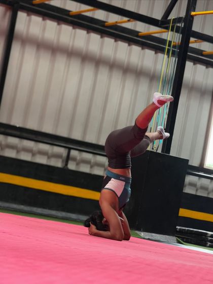 Practicing different leg variations in a headstand helps improve balance and core control in our adult gymnastics classes.