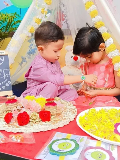 A sister ties a rakhi on her brother's wrist, a timeless tradition that we celebrate with great joy. These moments teach children about the importance of family bonds.