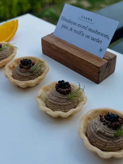 Our signature Himalayan morel mushroom, pâté, and truffle tartlets. This canapé highlights our commitment to using rare and exceptional regional ingredients, presented with an elegant touch for a truly gourmet bite.