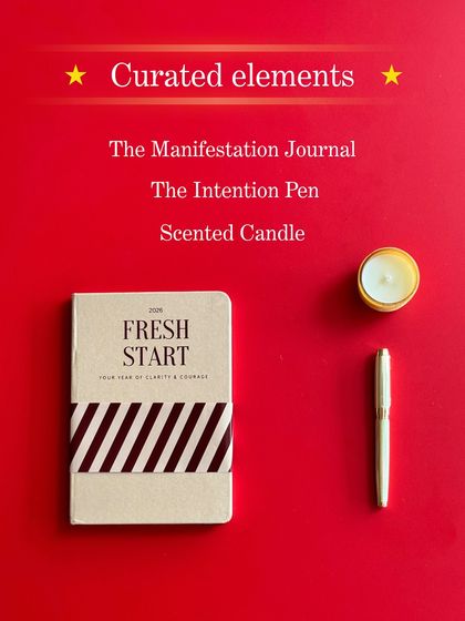 A flat lay of the "Curated Elements" in our "Reset Kit": The Manifestation Journal, The Intention Pen, and a Scented Candle. Three tools for one big shift.