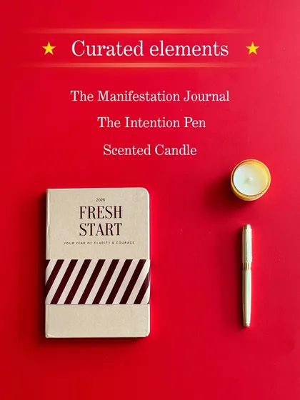 The curated elements of the Reset Kit: The Manifestation Journal, The Intention Pen, and a scented candle. Everything you need to clear your mind and set new goals.