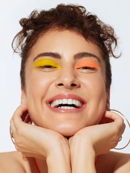 A beauty close-up where the focus is on the face. I kept the styling minimal to let the colorful makeup and the model's expression take center stage.