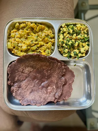 A high-protein meal with ragi roti, paneer bhurji, and a vegetable curry. Ragi is a great source of calcium and fiber.