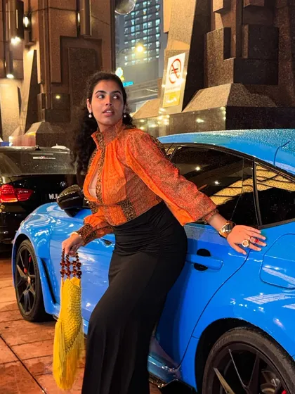 Another shot with the car. The blue of the car and the orange of my top are complementary colors, which is why they look so good together. I can teach you all about color theory.