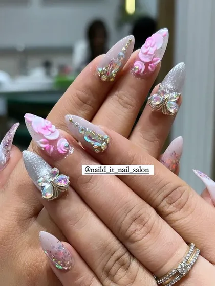 An example of our detailed 3D nail art. This set includes sculpted pink acrylic flowers and sparkling butterfly charms made of Swarovski crystals, all set on long, elegant stiletto extensions for a truly show-stopping effect.