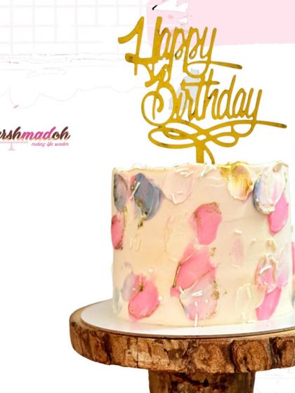It's pink and tall! This custom designer cake features a beautiful abstract, textured buttercream design in shades of pink, grey, and gold.